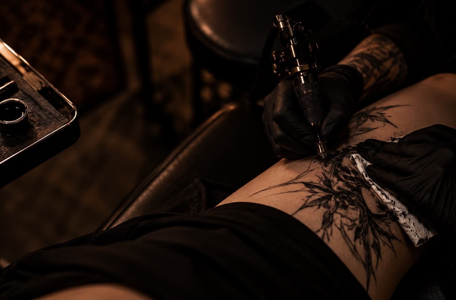 Tattoo artist working on a tattoo